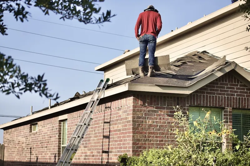 Professional roofer working on a residential roof in Petoskey